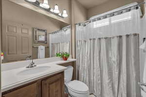 Bathroom with vanity and a shower with shower curtain