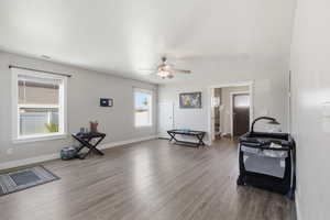 Living room with wood finished floors and ceiling fan
