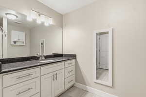 Bathroom featuring vanity and baseboards