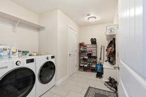 Washroom with independent washer and dryer and wood finish floors