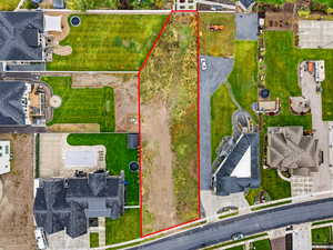 Aerial perspective of suburban area featuring property parcel outlined