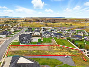 Aerial view of residential area with mountains and property parcel outlined