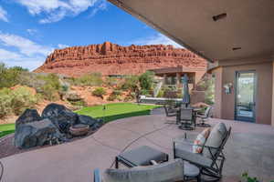 View of patio / terrace featuring a putting area, outdoor dining area, and a mountain view