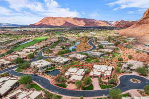 Aerial view of residential area featuring property boundaries highlighted, a water and mountain view, and a golf club