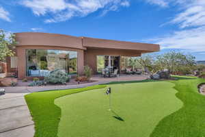 View of property's community with a putting area and a patio