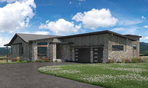 View of community featuring asphalt driveway, a garage, a mountain view, and a lawn