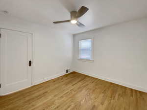 Spare room with wood finished floors and a ceiling fan