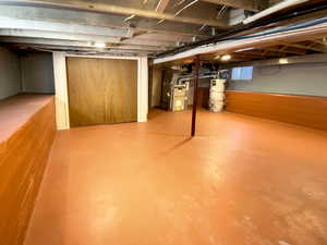 Basement with water heater and heating unit