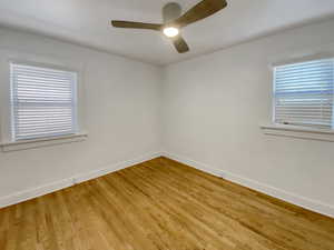 Unfurnished room with wood finished floors and ceiling fan