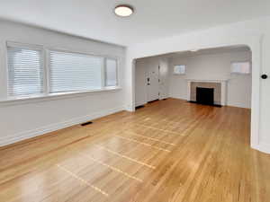 Unfurnished living room with light wood-style floors and a fireplace