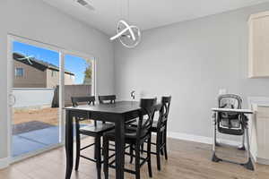 Dining room featuring light wood-type flooring and a chandelier