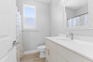 Full bath featuring light wood-type flooring, vanity, and a shower with curtain