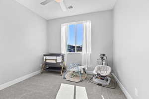 Playroom with carpet flooring and a ceiling fan