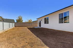 Fenced backyard with a patio area