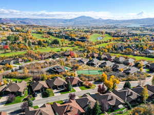 Aerial view of property's location featuring mountains and nearby suburban area