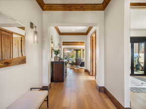 Corridor featuring crown molding and light wood-type flooring