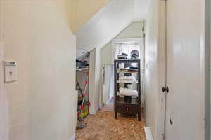 Walk in closet with lofted ceiling