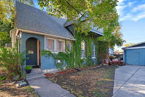 View of front of property featuring roof with shingles and stucco siding