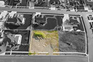 Aerial perspective of suburban area featuring property boundaries highlighted