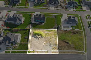 Aerial perspective of suburban area featuring property boundaries highlighted