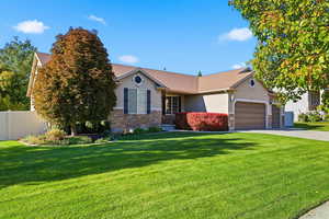 View of front of house with stucco siding, stone siding, a garage, concrete driveway, and roof with shingles