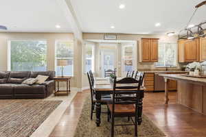 Dining area with dark wood-style flooring, recessed lighting, and beam ceiling
