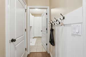 Hallway featuring light tile patterned floors