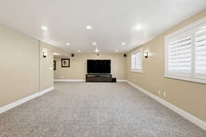 Basement with recessed lighting and light carpet