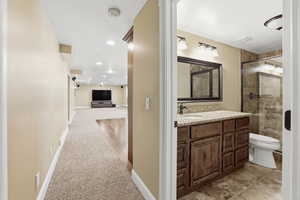 Full bath with vanity, a stall shower, light colored carpet, and recessed lighting