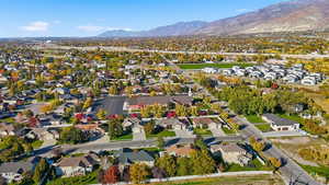 Aerial overview of property's location featuring nearby suburban area and a mountainous background