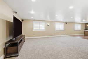 Unfurnished living room featuring light colored carpet and recessed lighting