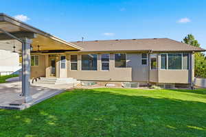 Rear view of house featuring a shingled roof, a patio area, a ceiling fan, and stucco siding