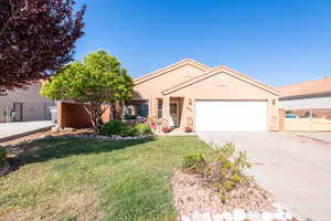 View of front of house with concrete driveway, stucco siding, a garage, and a tile roof