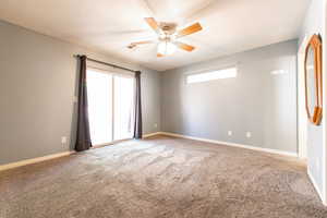 Empty room featuring light carpet, a ceiling fan, and a textured ceiling
