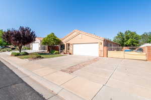 Ranch-style home with a gate, stucco siding, driveway, and a garage