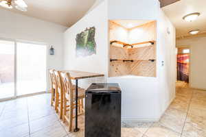 Dining room featuring light tile patterned floors and baseboards