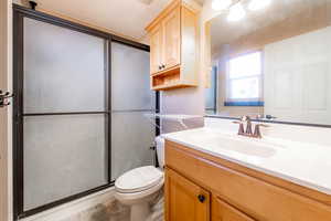 Bathroom with a shower stall and vanity