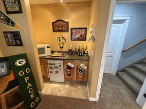 Hall featuring light colored carpet and stairway