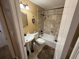 Bathroom with shower / bath combo and tile patterned floors