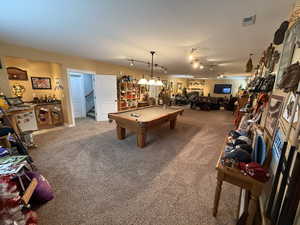 Game room featuring billiards table, light carpet, bar, and rail lighting
