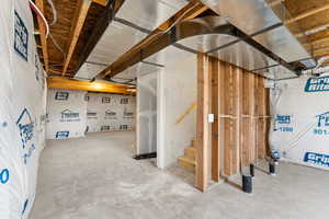 Unfinished below grade area featuring stairway