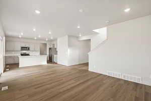 Unfurnished living room with light wood finished floors and recessed lighting