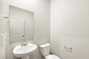 Half bathroom with toilet and a sink