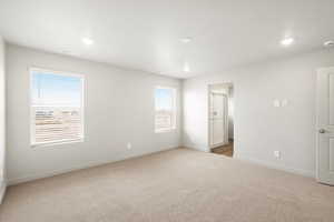 Empty room with light colored carpet, recessed lighting, and a smoke detector
