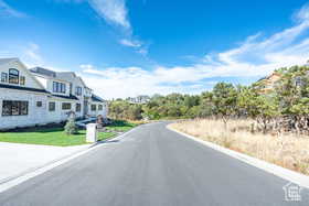 View of asphalt street featuring curbs
