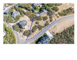Aerial view of property and surrounding area with property parcel outlined