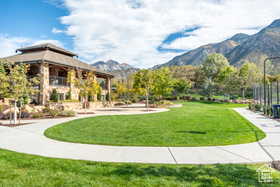 View of community featuring a lawn and a mountain view