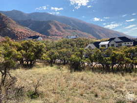 View of mountain backdrop featuring rural landscape and a tree filled landscape