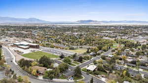 Aerial overview of property's location with a mountainous background and nearby suburban area