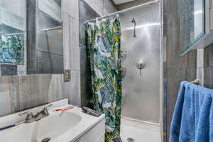 Bathroom featuring vanity and a stall shower